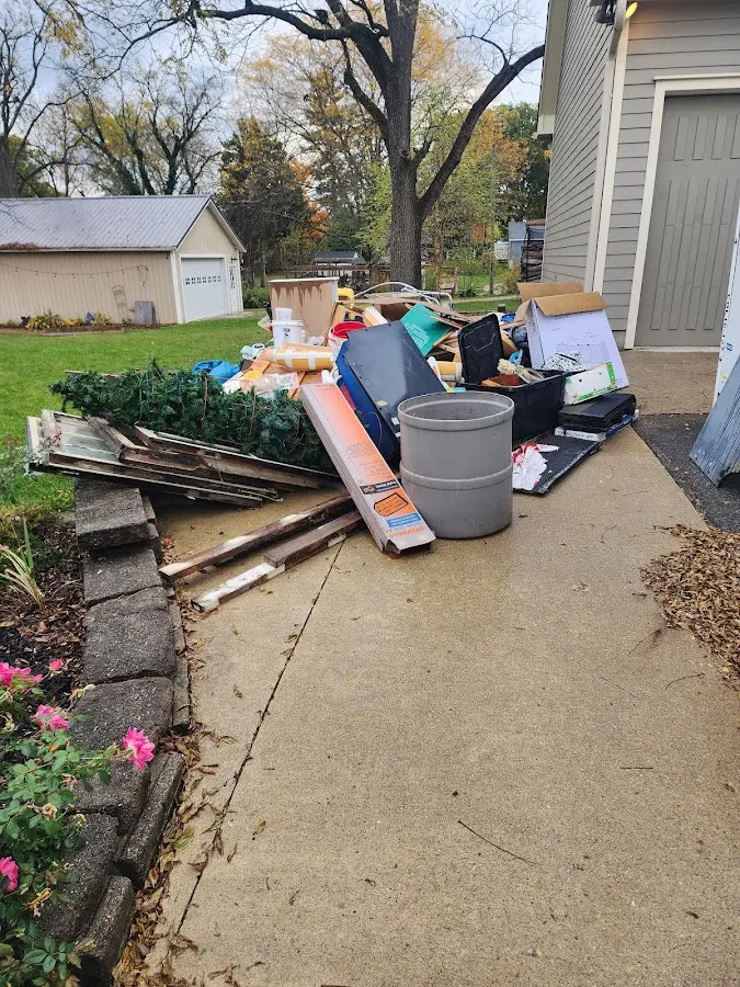 Dumpster being loaded with debris for Commercial Dumpster Rental in Lincoln